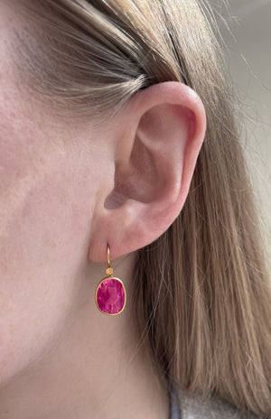 Close-up view of model wearing Ruby Pebble Drop Earring by Lola Brooks on left ear